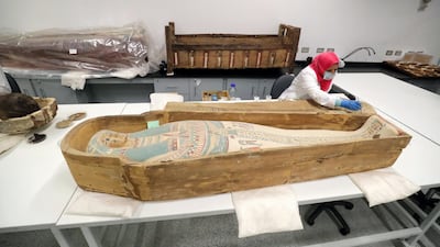 An Egyptian archaeologist restores the coffin of King Tutankhamun at the conservation center in the Grand Egyptian Museum. For the first time since the tomb was discovered in 1922, the coffin was transported from King Tutankhamun's tomb at the Valley of the Kings in Luxor to the Grand Egyptian Museum for an eight-month restoration process, before being displayed among his treasured collection at the museum. Tutankhamun is the formal name of the mummified pharaoh most tourists visiting Egypt's Valley of the Kings know as King Tut. AFP