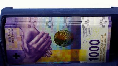 A bunch of 1,000 Swiss-franc banknotes in a box at a Swiss bank in Zurich. The country has been accused by the US Treasury Department of keeping its currency artificially low. Reuters