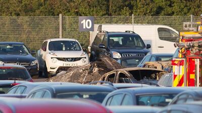 Debris from the Embraer Phenom 300 jet that crashed in a car sales lot near Blackbushe Airport in southern England on July 31, 2015. Daniel Leal-Olivas / PA via AP