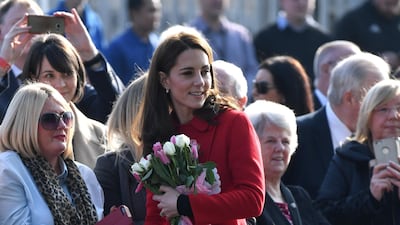 Arriving in Northern Ireland for an unannounced visit with Prince William, the Duchess of Cambridge wears a red Carolina Herrera coat, black jeans and LK Bennett Marissa booties. EPA