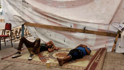 Opposition demonstrators lie on the ground near Egypt's Presidential Palace in the suburb of Heliopolis Ed Giles / Getty Images