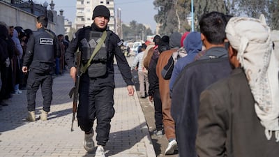 Members of the Kurdish-led Syrian Democratic Forces queue to settle their status with the Syrian government, in Raqqa. Reuters