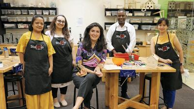 Lina Sadek, owner of Studiyo lab with her team members at the Times Square Centre mall in Dubai. Ms Sadek is among innovative tenants driving footfall in a refreshed Times Square Centre. Photo: Pawan Singh / The National