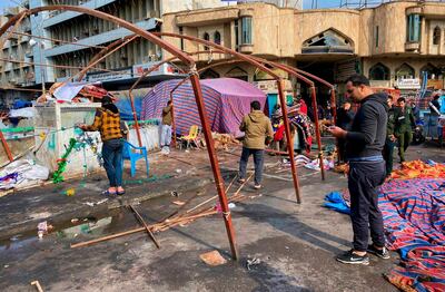 Followers of Shiite cleric Moqtada Al Sadr dismantle their tents in preparation for withdrawing from the anti-government protests in Tahrir Square. AP