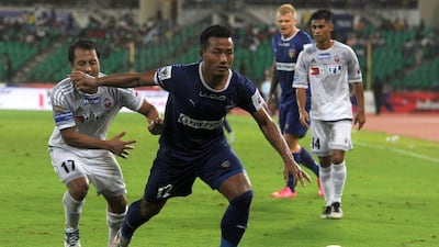 Chennaiyin FC' forward Jeje Lalpekhlua, centre, vies for the ball with FC Pune City defender Yamnam Raju. Arun Sankar / AFP