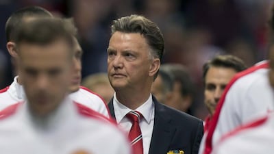 Manchester United's new manager Louis van Gaal, centre, is repeating his plea for patience on the season. Jon Super / AP Photo