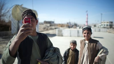An Afghan youth uses his mobile phonearound the town of Musa Qala on January 18, 2011. The top US military officer said January 12 he sees an increase in bloodshed in Afghanistan as allied forces step up their offensive against the Taliban. AFP