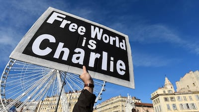 Days after three gunmen killed 17 people in Paris, a man holds a placard during a unity rally in the old harbour in Marseille, southern France. There were similar demonstrations in support of free speech held around the world. Anne-Christine Poujoulat / AFP Photo