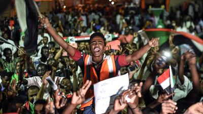 Sudanese protesters wave flags as they gather for a sit-in outside the military headquarters in Khartoum. Two days of talks between Sudan's ruling military council and protesters ended in a stalemate with no clear leader for the country's transitional government. AFP