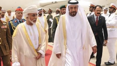 Sultan Qaboos bin Said, the ruler of Oman, is greeted at Al Ain International Airport yesterday by Sheikh Khalifa, President of the UAE.