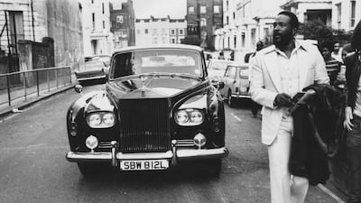 American singer Marvin Gaye walking ahead of his Rolls Royce in Notting Hill, London, in 1976.