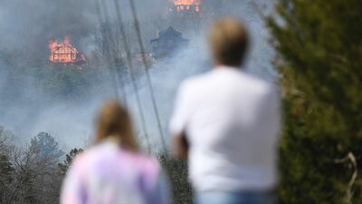Firefighters sought to get a handle on a wildfire spreading near Great Smoky Mountains National Park in Tennessee, amid mandatory evacuations as winds whipped up before a line of strong storms forecast to move in overnight. Knoxville News Sentinel / AP