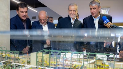 Iranian President Masoud Pezeshkian, second right, and the chief of the country's Atomic Energy Organisation, Mohammad Eslami, right, in Tehran. AFP