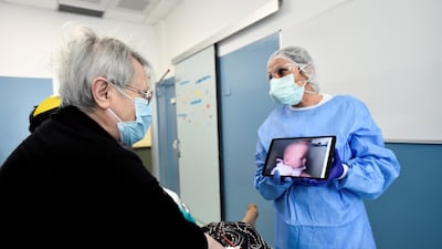 A patient suffering from coronavirus uses a tablet to speak to a relative who is unable to visit, at the Cernusco sul Naviglio hospital in Milan, Italy. Reuters