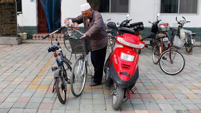 A Hui Muslim man parks his bicycle and grabs a towel on his way to prayer. Sarah Dea / The National