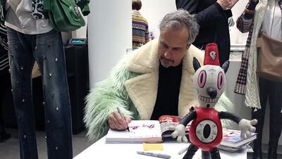 Gary Baseman signs copies of his book during the Coach SS15 preview in Paris (Courtesy of Coach)