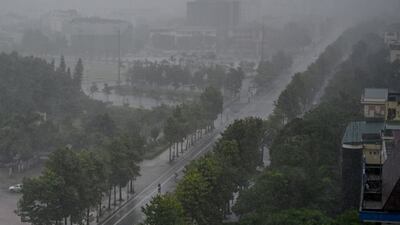 Rain falls over buildings and a street in Vinh city before Typhoon Kajiki’s landfall in Vietnam. AFP