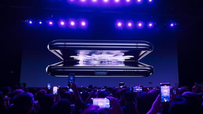 The Samsung Galaxy Z Flip smartphone is displayed on screen. Bloomberg