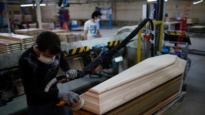 An employee works on a coffin at the manufacturing plant OGF in Jussey as the spread of the coronavirus disease continues in France. Reuters