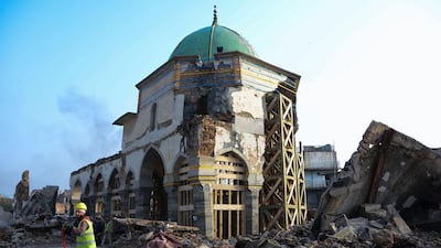 An Iraqi worker clears rubble during the reconstruction of the Great Mosque of Al-Nuri in Mosul. AFP