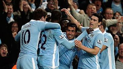 Carlos Tevez celebrates with his teammates after Samir Nasri (hidden) scored against Chelsea.