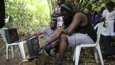 Director Kunle Afolayan watches a monitor while directing a scene during the filming of police thriller ‘October 1’ at a rural location in Ilaramokin village, Nigeria.
