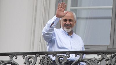 Iranian Foreign Minister Mohammad Javad Zarif waves from a balcony of the Palais Coburg Hotel where a historic agreement over Iran's nuclear programme is expected to be announced on Tuesday. AFP PHOTO/JOE KLAMAR