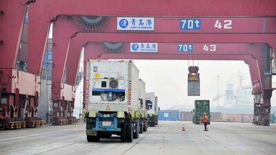 Cargo trucks move through a shipping port in Qingdao in eastern China's Shandong province. Exports from the country have rebounded. AP