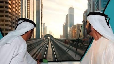 Sheikh Mohammed, right, rides the Metro after touring the new Concourse 3 terminal at Dubai International Airport. Wam
