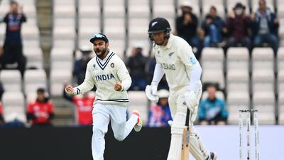 India captain Virat Kohli celebrates the wicket of New Zealand's Ross Taylor for 11. Getty