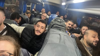 Syrians unable to land in Aleppo are taken to hotels on airline buses. Lizzie Porter / The National