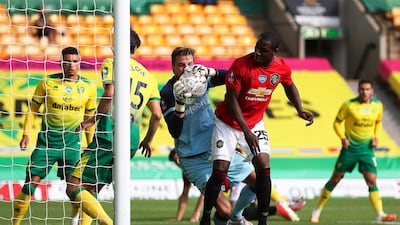 Norwich goalkeeper Tim Krul makes a save under pressure from United's Odion Ighalo. EPA