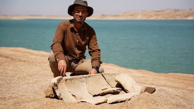 Bekas Brefkany, director of the Dohuk Antiquities Department, by a grave on the banks of Mosul Dam. All Photos: AFP
