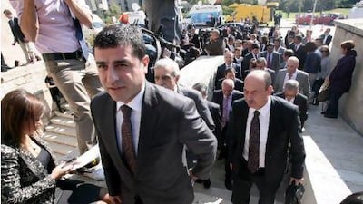 The newly elected MPs of the pro-Kurdish Peace and Democracy Party and its chairman, Selahattin Demirtas, (foreground) seen arriving outside the parliamentary building in Ankara as they ended a four-month boycott of the Turkish parliament. ADEM ALTAN / AFP PHOTO