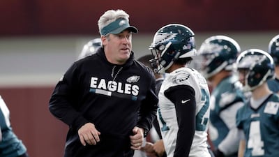 Philadelphia Eagles head coach Doug Pederson runs past players during a practice for the NFL Super Bowl. Eric Gay / AP Photo