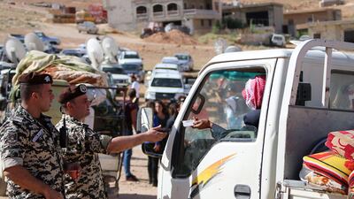 Lebanese security forces check identity and papers of Syrian refugees getting ready to cross into Syria from the eastern Lebanese border town of Arsal, on June 28, 2018. Stringer / AFP
