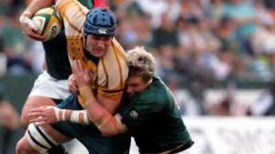 South Africa's Jean de Villiers, right, tackles Australia's James Horwill, left, during the Tri Nations match at the ABSA stadium in Durban, South Africa, yesterday.