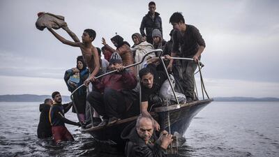 A handout image provided by the World Press Photo (WPP) organisation on 18 February 2016 shows a picture by Russian photographer Sergey Ponomarev for The New York Times that won First Prize Stories in the General News Category of the 59th annual World Press Photo Contest, it was announced by the WPP Foundation in Amsterdam, The Netherlands on 18 February 2016. The picture shows migrants and refugees arrived by boat in November 2015 near the village of Skala on the Greek island of Lesbos. Under Europe’s system of open internal borders, the island’s thinly patrolled, easily accessible coastline, within sight of the Turkish coast, might as well be the frontier of France or Germany or Sweden. Sergey Ponomarev / EPA