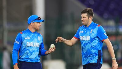 England's Jamie Overton with Jos Buttler, left, during their Champions Trophy defeat against South Africa in Karachi. Reuters