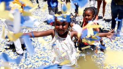 Golden State Warriors fans Zeynab Camara and her sister Maimouna Camara play in the confetti. Monica M. Davey / EPA