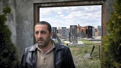 A Yazidi man leaves the graveyard at the Quba Mere Diwane temple, the world's largest Yazidi place of worship, in Aknalich, Armenia. Kiran Ridley for The National