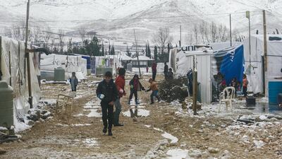 Syrian boys play with snowballs at the Deir Zeinoun refugee camp in the Beqaa Valley, eastern Lebanon, on January 28, 2017. Hassan Jarrah / AFP