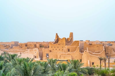 Silhouette of Salwa Palace in At-Turaif in Ad Diriyah with palm trees in foreground. Photo: DGDA