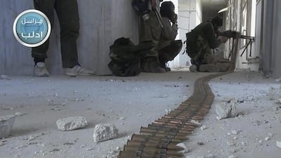 Members of Al Nusra Front take their positions as they fight against the Syrian government forces in Idlib province. Al Nusra Front Twitter page via AP