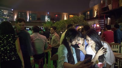 In this June 11, 2015 photo, Indian girls take a selfie at a party hosted by TrulyMadly, one of India’s online dating apps in Gurgaon, India. The dating app market in India has exploded in recent years, with more than a dozen companies operating in the country and more than a million smartphone users who have downloaded at least one of them. Tsering Topgyal/AP Photo
