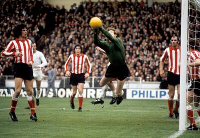 Sunderland goalkeeper Jim Montgomery makes a flying save as Richie Pitt, Vic Halom and Dick Malone look on. Getty Images