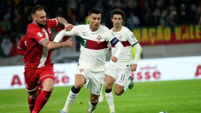 Portugal's Cristiano Ronaldo fights for the ball against Luxembourg's Maxime Chanot. AP Photo