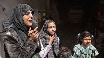 Survivors of an air strike by government forces that destroyed two five-storey apartment blocks and severely damaged 10 buildings in a residential neighbourhood of Aleppo.