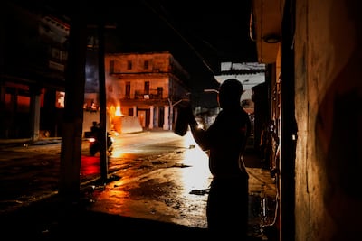 A person bangs a pot to protest against prolonged power outages as Havana faces its worst rolling blackouts in decades. Reuters
