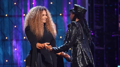 Janelle Monae, right, presents a trophy to inductee Janet Jackson. AP